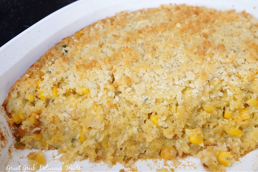 A baking dish with corn casserole in it.