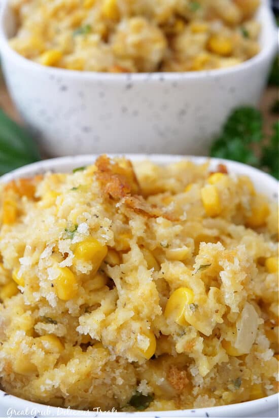 A close up of a serving of corn casserole in a white bowl.