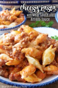 Cheesy Pasta with Meat Sauce and Alfredo Sauce is an incredibly delicious and hearty ground beef and Italian sausage pasta recipe with two types of sauces, and lots of cheese.