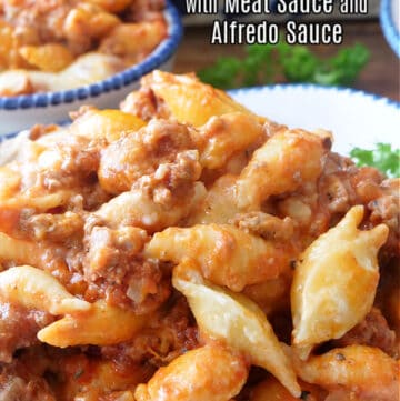 Cheesy Pasta with Meat Sauce and Alfredo Sauce is an incredibly delicious and hearty ground beef and Italian sausage pasta recipe with two types of sauces, and lots of cheese.