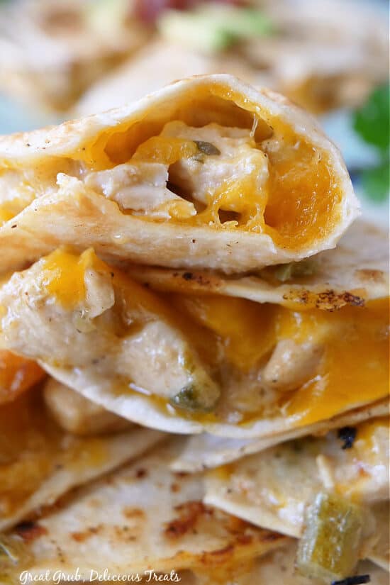 A close up picture of a stack of cheesy chicken quesadillas. 