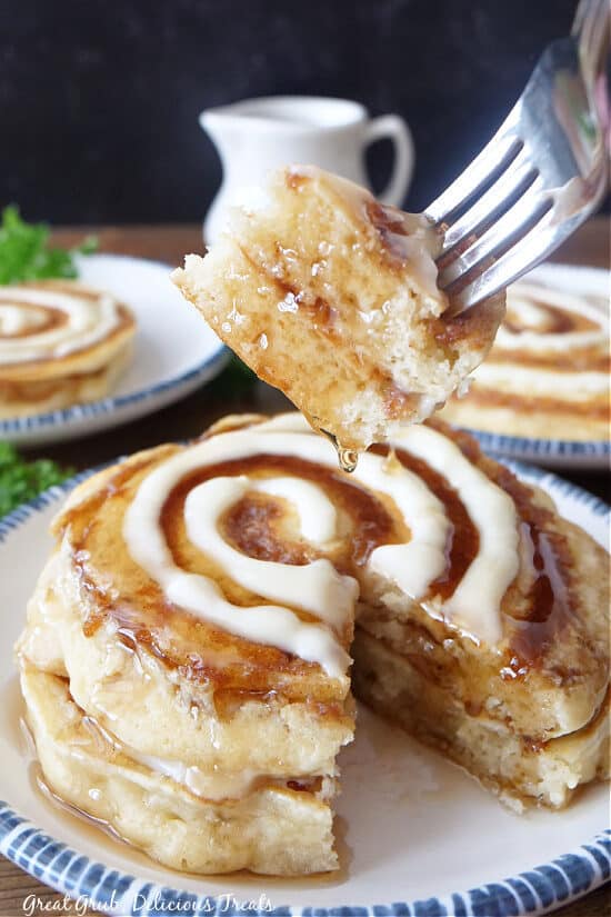 A bite of pancakes on a fork.