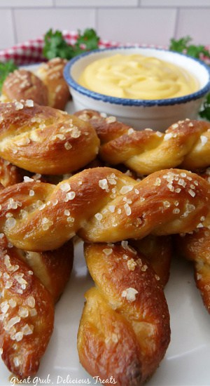 A close up picture of pretzel twists on a white plate. 