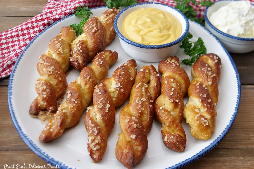 An overhead shot of a plate with seven pretzel twists on it.
