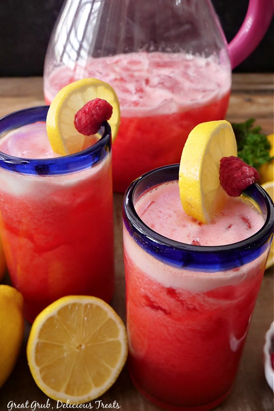 A close up photo of two glasses with homemade raspberry lemonade in them.