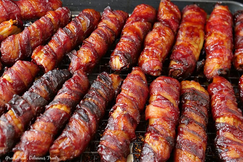 A rack full of stuffed manicotti shells wrapped in bacon after being smoked on the Traeger.