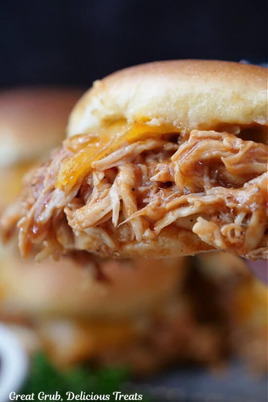 A close up of a BBQ Chicken Slider held close to the camera lens.