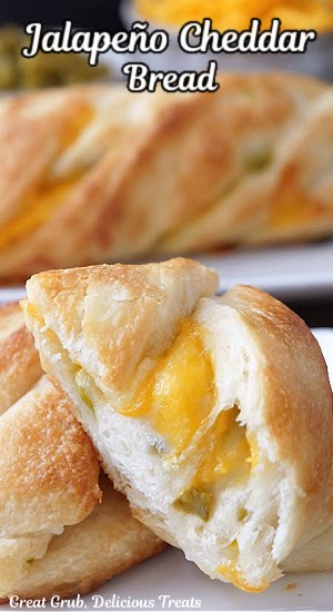 A close up of a couple pieces of cheese bread on a white plate.