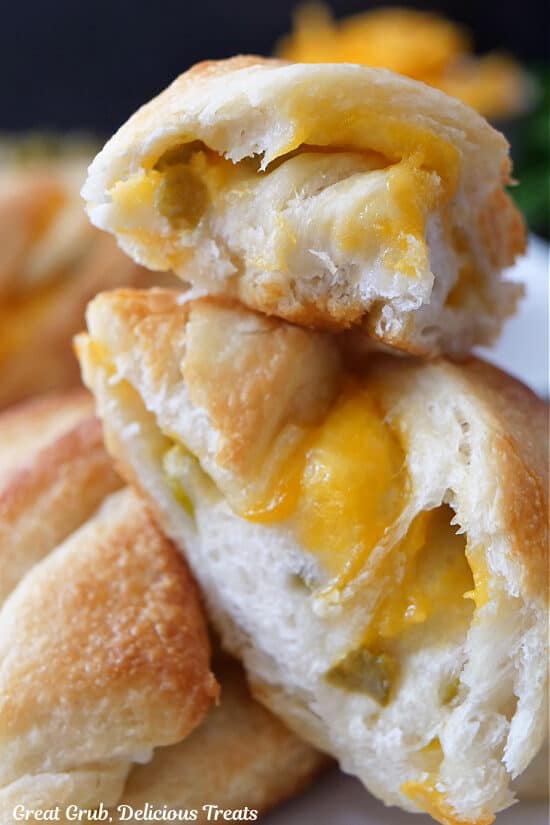 A close  up of three slices of cheese bread on top of each other.