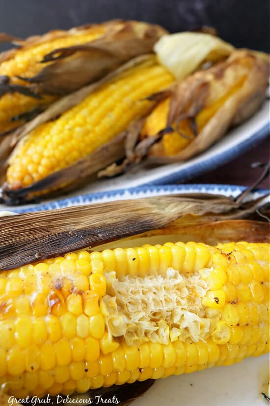 A big bite taken out of a cob of corn.