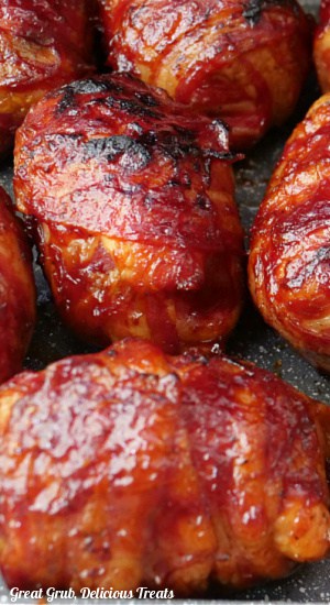 A close up of bacon wrapped chicken bombs.
