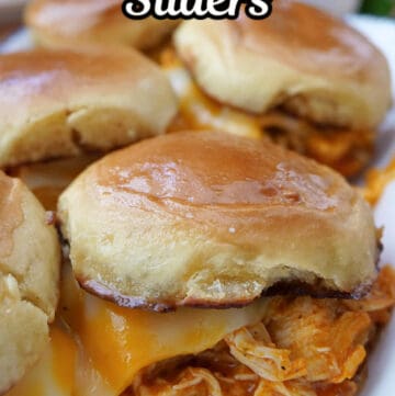 A white plate with five buffalo chicken sliders on it with the title of the recipe at the top of the photo.