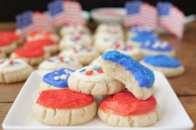 A horizontal photo of red, white, and blue 4th of July sugar cookies on a white plate.