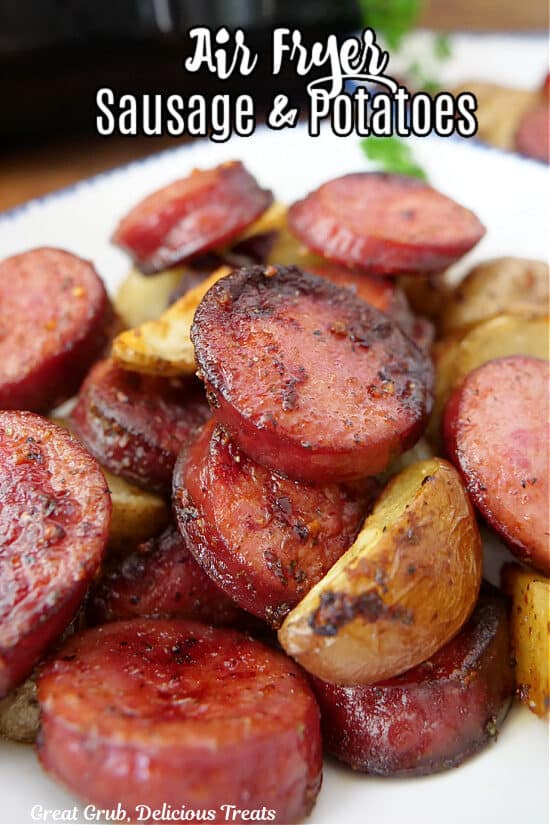 A white plate with blue trim with smoked sausage and potatoes on it.