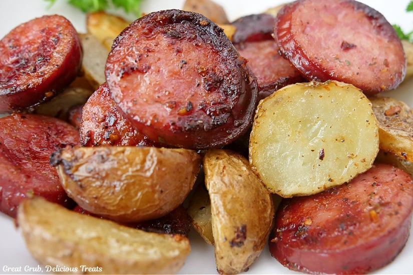 A close up photo of sliced smoked sausages and baby potatoes that were air fried.