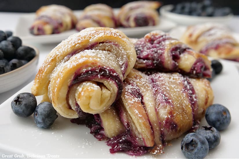 A horizontal photo of blueberry pastries on a white plate.