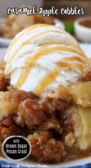 A close up of a bowl of apple cobbler with vanilla ice cream on top and drizzled with caramel.