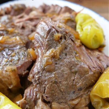 A slow cooked roast on a white plate.