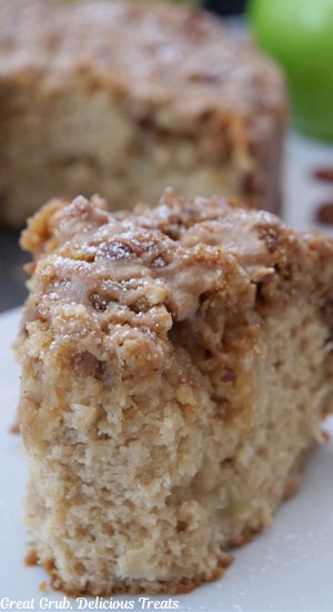 A slice of apple coffee cake on a white plate.