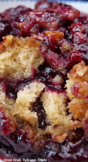 A close up photo of cherry cobbler with brown sugar pecan crust topping.