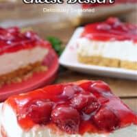 Three plates with a serving of cherry cream cheese dessert on each plate.