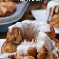A mini cinnamon roll monkey bread with icing on it with a few pieces pulled off.