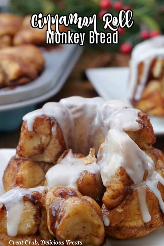 A mini cinnamon roll monkey bread with icing on it with a few pieces pulled off.