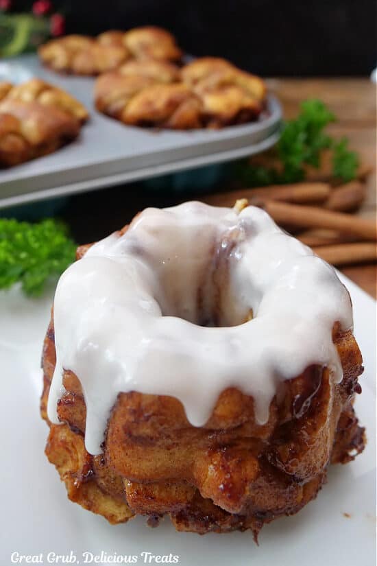 A mini monkey bread with white icing drizzled over the top.
