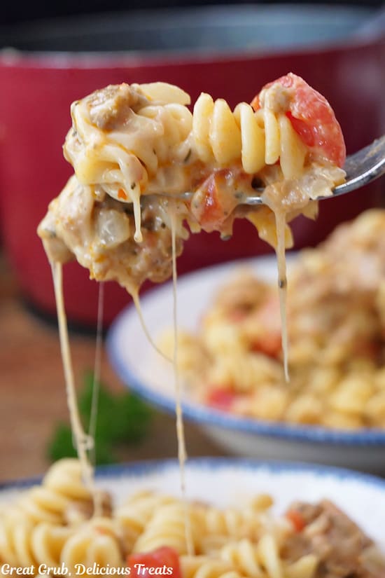 A close up of a bite of Italian sausage pasta on a fork.