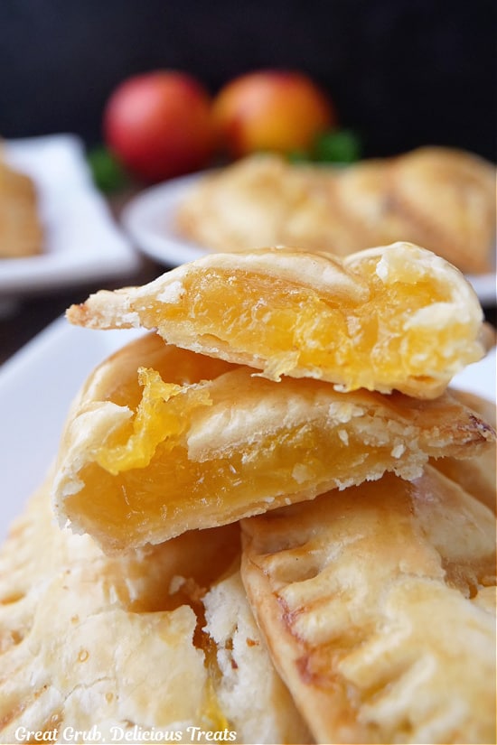A close up of nectarine hand pies on a white plate.