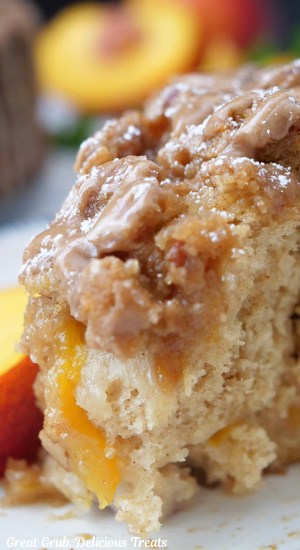 A close up slice of coffee cake with fresh peaches added.
