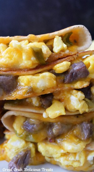 A close up of a stack of breakfast quesadillas.