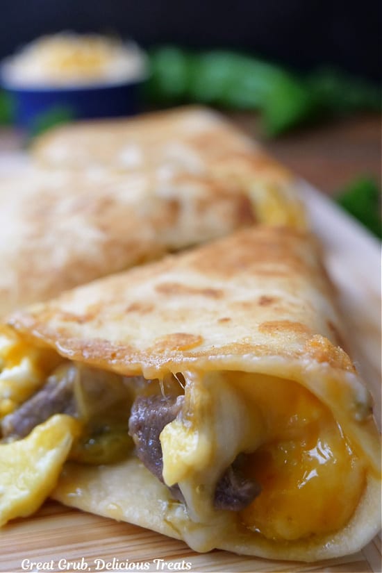 A close up of a quesadilla with eggs, steak, and cheese.