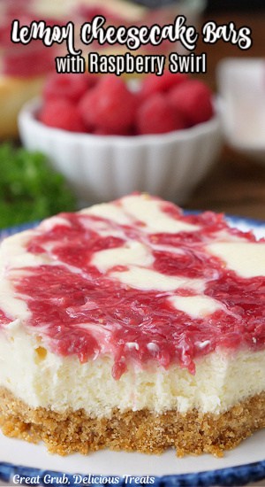 A serving of lemon cheesecake bars with a raspberry swirl on top.