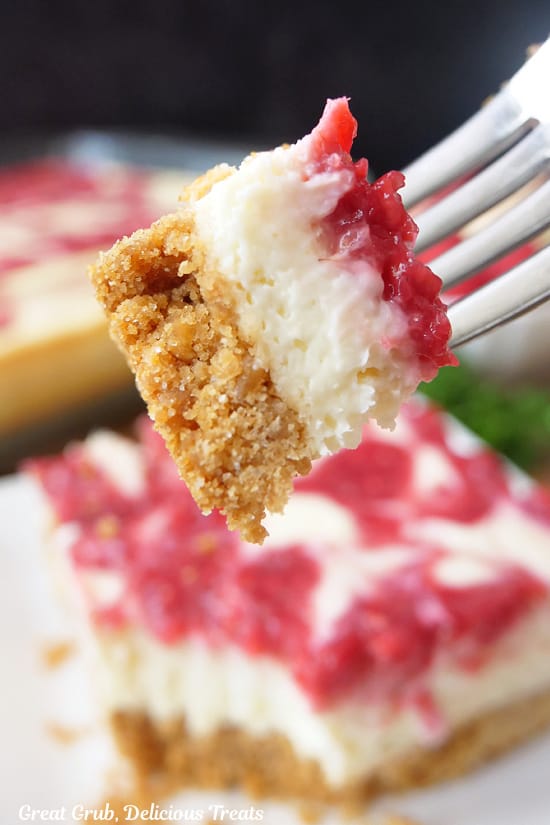 A close of of a bite of cheesecake on a fork.