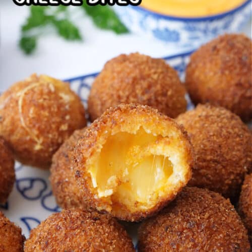 A white and blue plate with crispy cheese bites on it with a bite taken out of one of them.