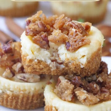 A white plate with three mini cheesecakes on it that is topped with a crunchy brown sugar pecan topping.