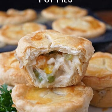 Seven mini chicken pot pies with a bite taken out of one of them.