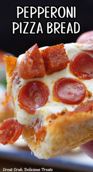 A close up of a piece of pepperoni pizza bread.