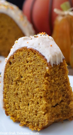 A piece of pumpkin cake on a white plate.
