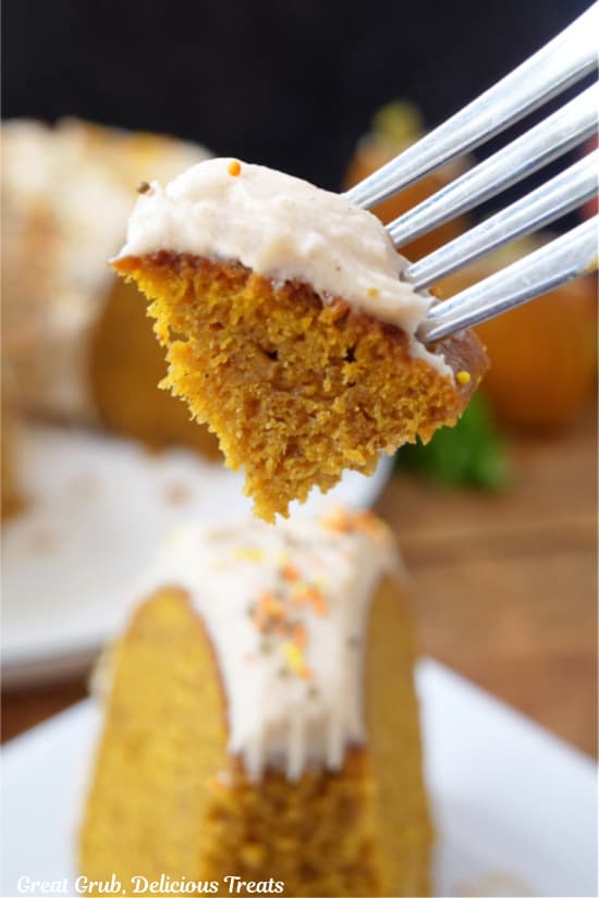 A bite of pumpkin cake on a fork.