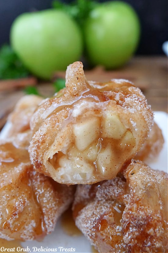 A bite taken out of a fried apple pie wonton showing the apple filling inside.