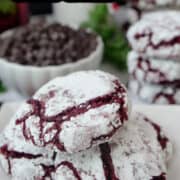 A few cookies on a white plate with festive decoration in the background.