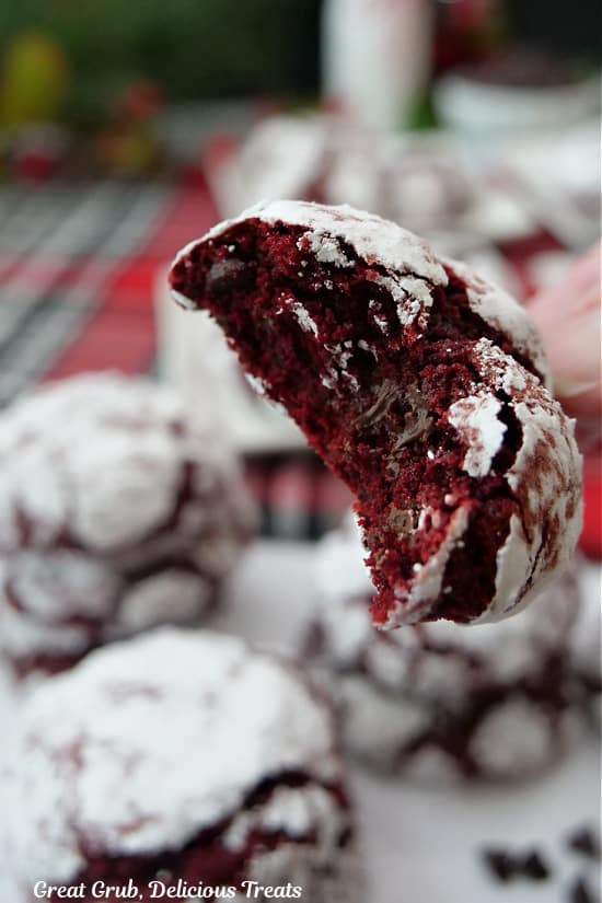 A close up of a red velvet cookie with a bite taken out of it.