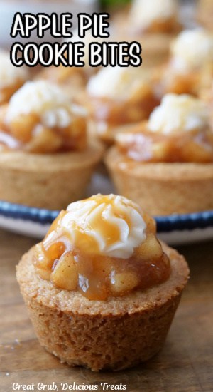 A single mini cookie cup filled with apple filling with more in the background.