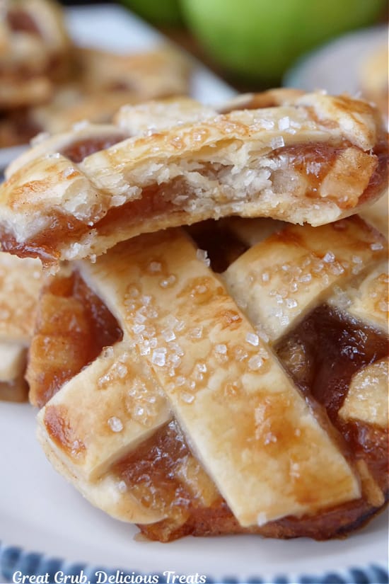 A close up of a few cookies made to look like little apple pies.