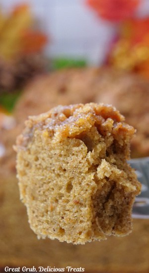 A close photo of a bite of butternut squash bread on a fork.