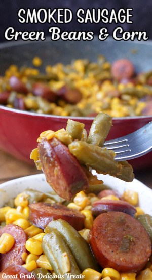 A serving bowl and a skillet filled with sausage, green beans and corn, and a fork with a bite on it.