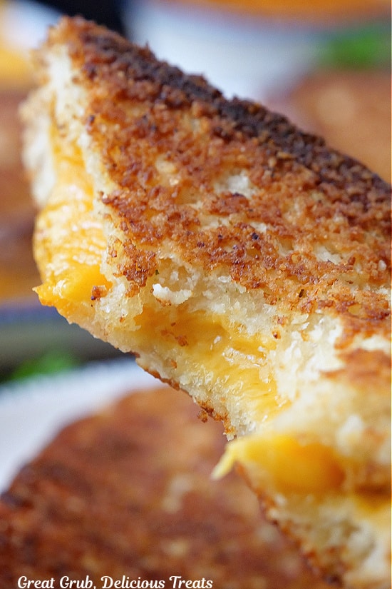 A close up of a Parmesan crusted grilled cheese with a bite taken out of it.