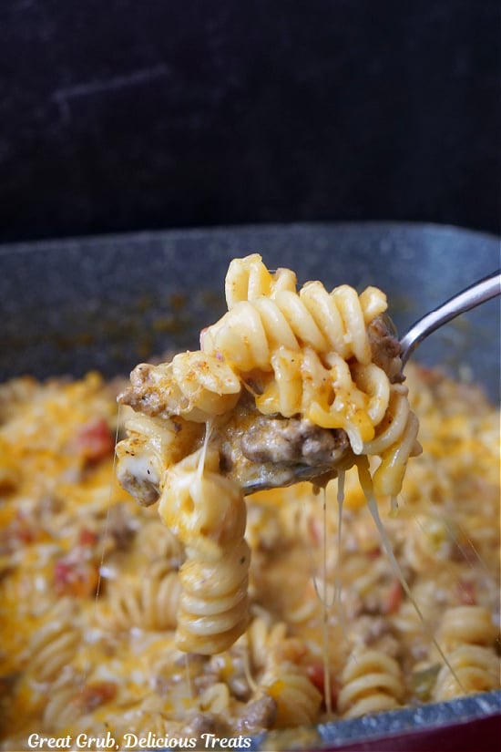 A spoonful of pasta being scooped out of the pan.